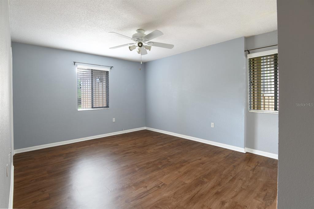 507 Northwest 39th Road, Unit 215 Gainesville, FL 32607 - Photo 9 of 21 a view of an empty room with wooden floor and a window