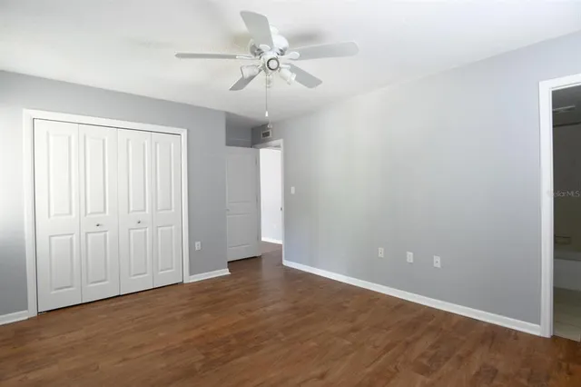 a view of an empty room with a fan