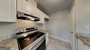 a kitchen with stainless steel appliances granite countertop a stove and a refrigerator