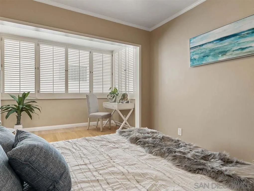 230 Prospect Street, Unit 17 La Jolla, CA 92037 - Photo 15 of 25 a bedroom with a bed and a window
