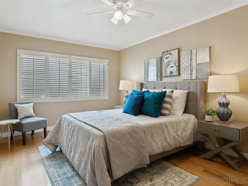 230 Prospect Street, Unit 17 La Jolla, CA 92037 - Photo 17 of 25 a bedroom with a bed and wooden floor