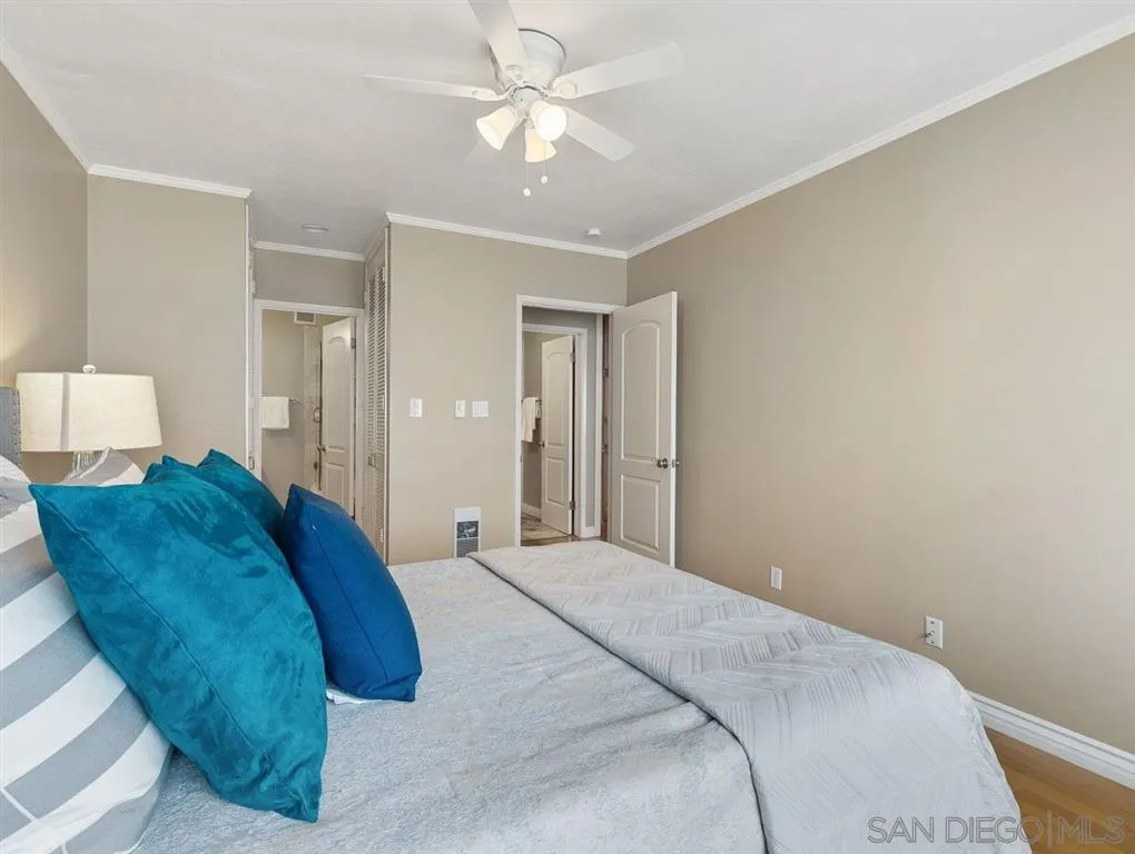 230 Prospect Street, Unit 17 La Jolla, CA 92037 - Photo 18 of 25 a bedroom with a large bed and a ceiling fan