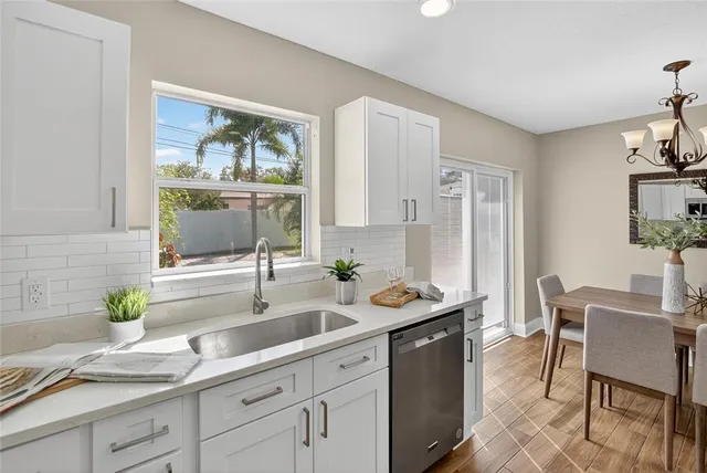 a kitchen with stainless steel appliances a sink and a refrigerator
