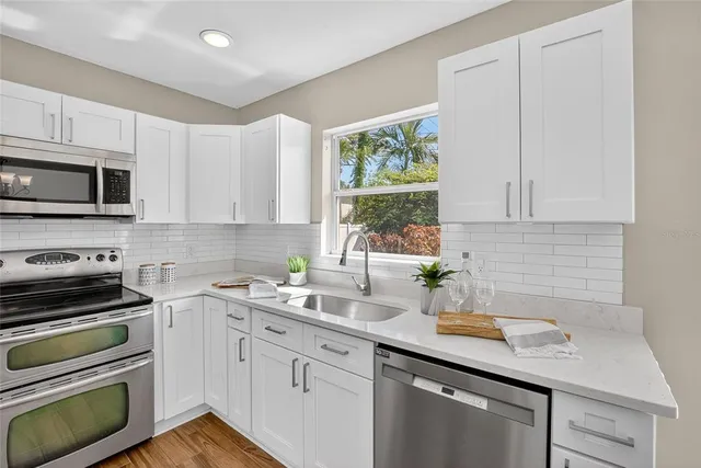 a kitchen with a sink stove and microwave