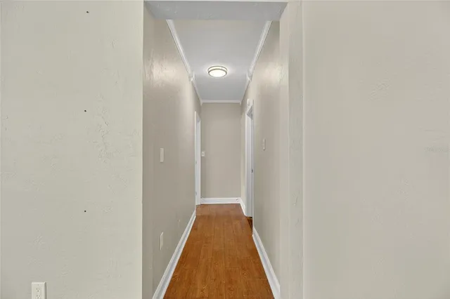 a view of a hallway with wooden floor