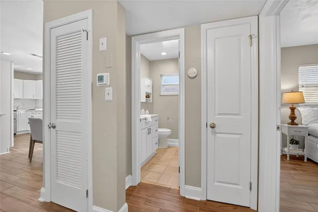 a view of a hallway with dining room and wooden floor