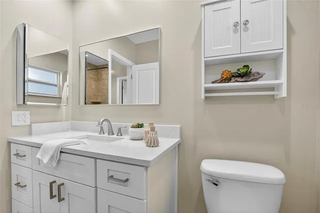 a bathroom with a sink a toilet and a window