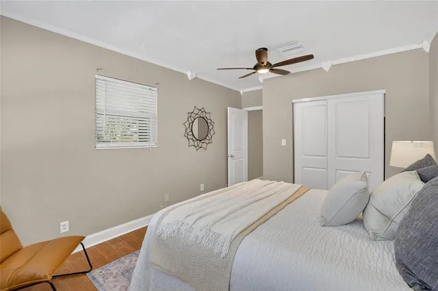 a bedroom with a bed and a ceiling fan
