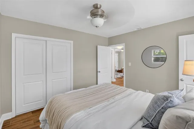 a bedroom with a bed and a chandelier