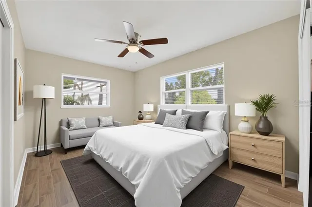 a bedroom with a bed and wooden floor