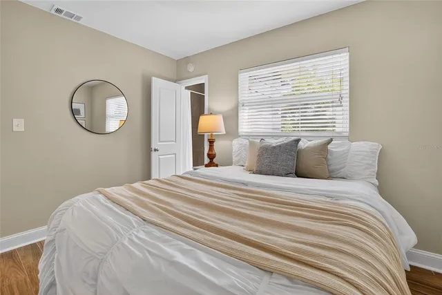 a bedroom with a bed and a large window