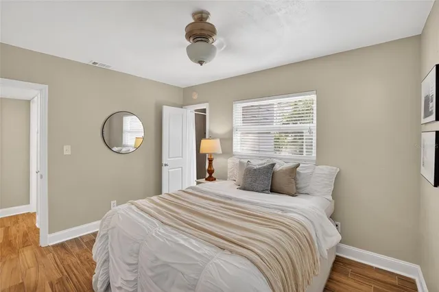 a bedroom with a large bed and a large window