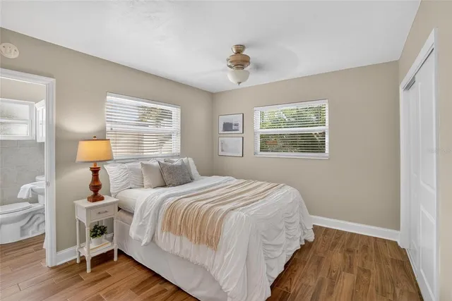 a bedroom with a bed and wooden floor