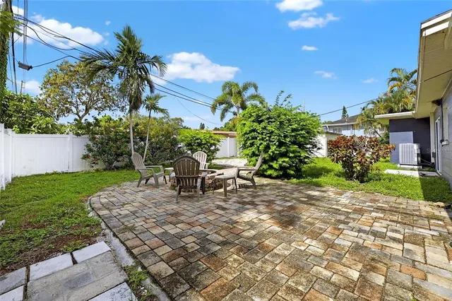 a view of a backyard with plants and a patio