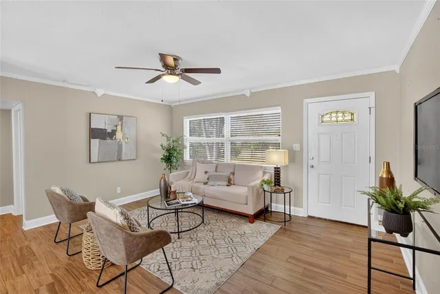 a living room with furniture and wooden floor