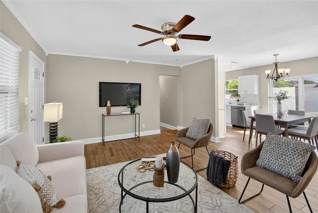 a living room with furniture a rug and a flat screen tv