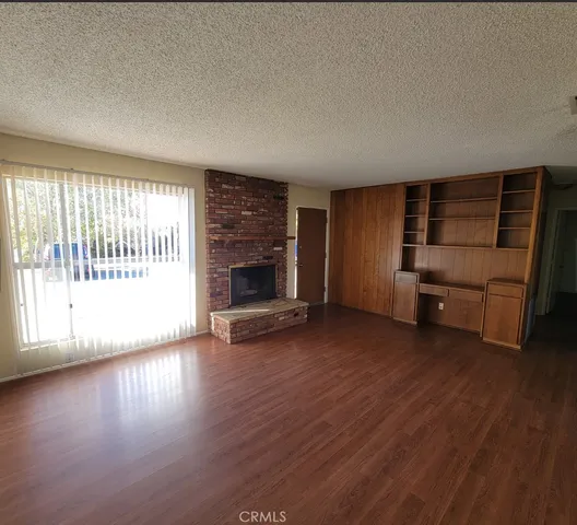 an empty room with furniture and wooden floor