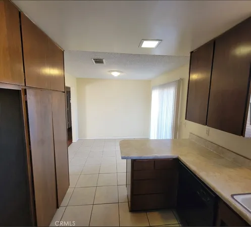 a kitchen with cabinets and wooden floor