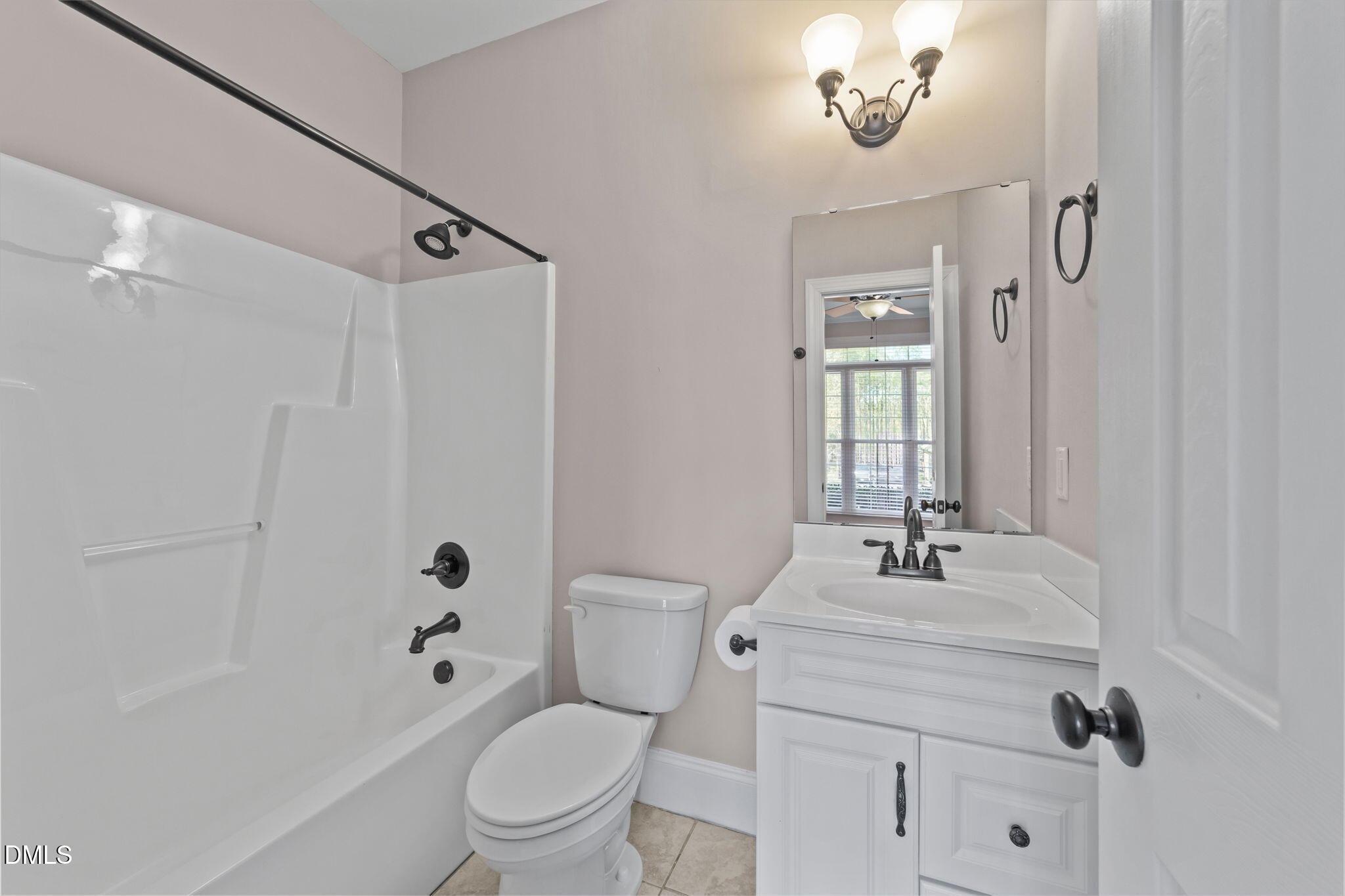 1405 Wakefield Farm Road Zebulon, NC 27597 - Photo 27 of 64 a bathroom with a sink a toilet a mirror a vanity and shower