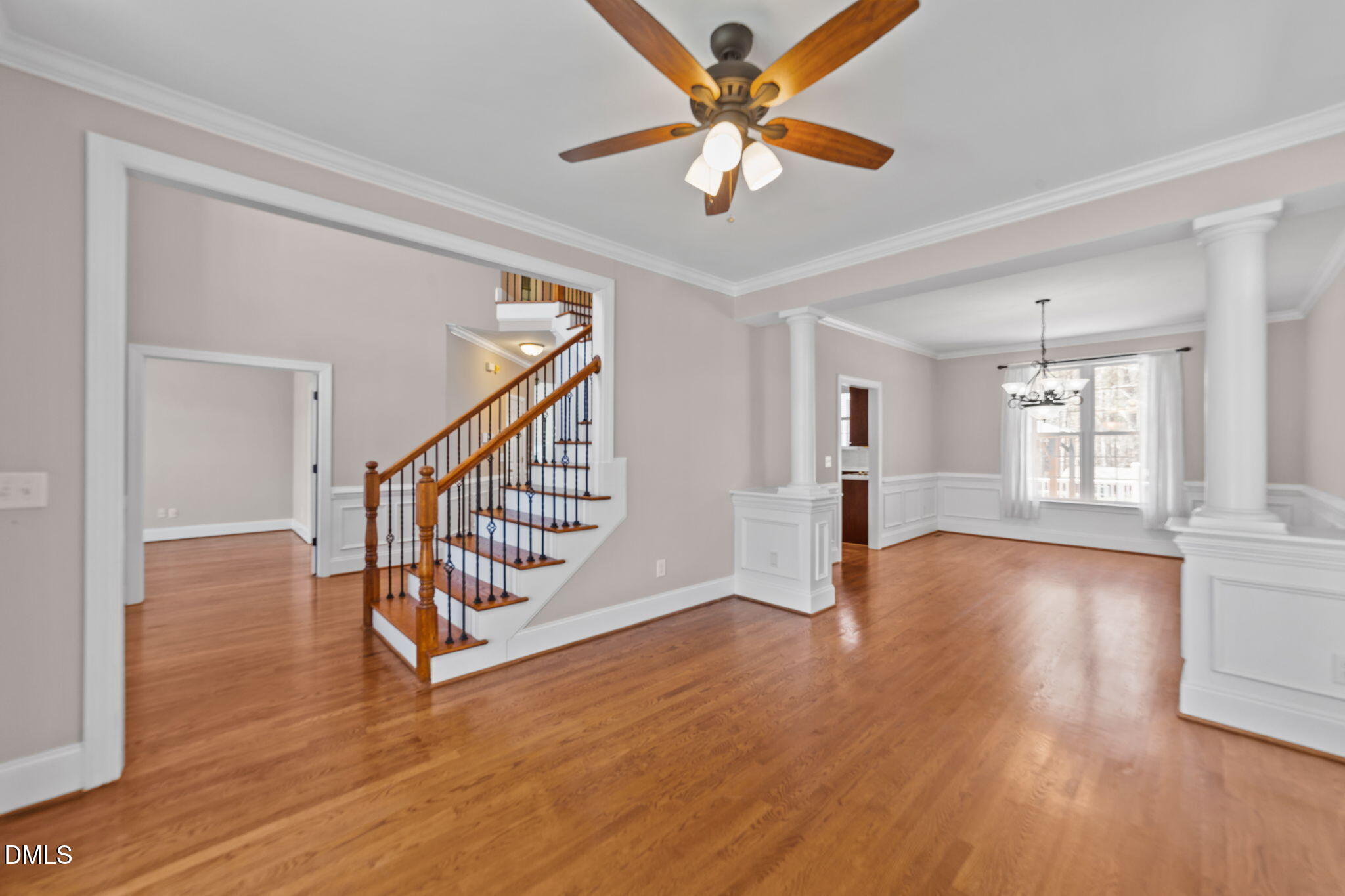 1405 Wakefield Farm Road Zebulon, NC 27597 - Photo 28 of 64 a view of an empty room with wooden floor and a ceiling fan