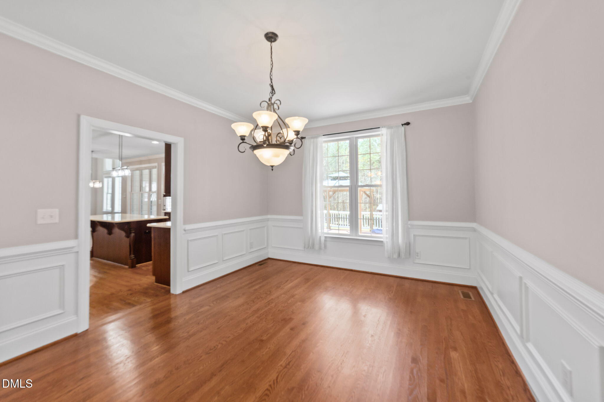 1405 Wakefield Farm Road Zebulon, NC 27597 - Photo 30 of 64 a view of an empty room with wooden floor and a window