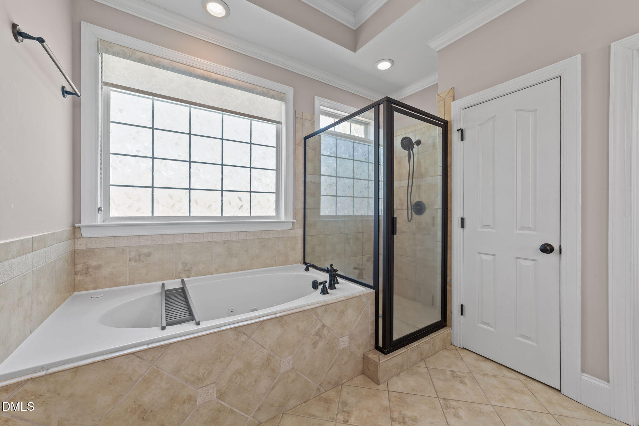 1405 Wakefield Farm Road Zebulon, NC 27597 - Photo 40 of 64 a spacious bathroom with a tub shower and window