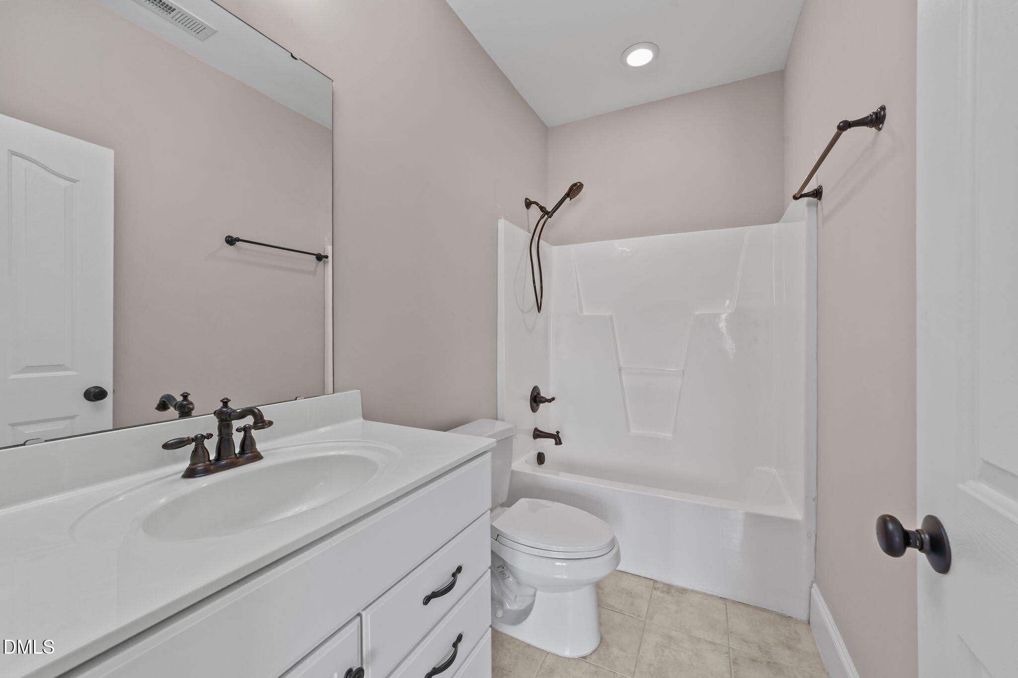 1405 Wakefield Farm Road Zebulon, NC 27597 - Photo 45 of 64 a bathroom with a sink toilet and shower
