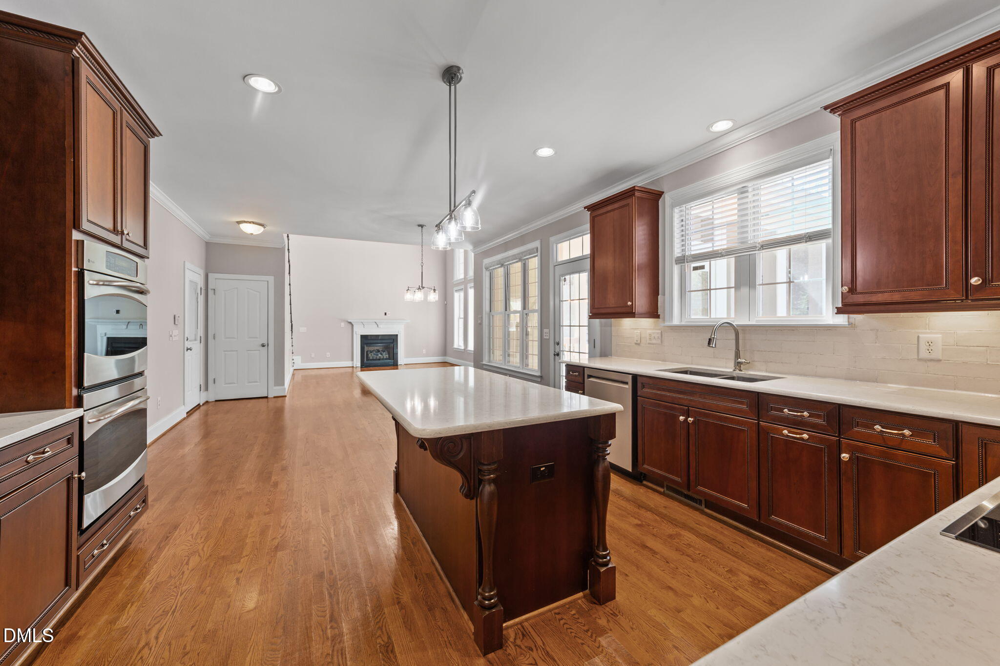 1405 Wakefield Farm Road Zebulon, NC 27597 - Photo 57 of 64 a large kitchen with stainless steel appliances granite countertop a sink a stove and a wooden floors