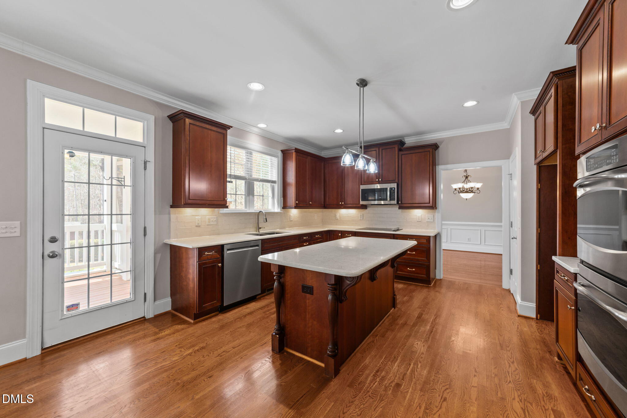 1405 Wakefield Farm Road Zebulon, NC 27597 - Photo 58 of 64 a large kitchen with a large counter top space a sink stainless steel appliances and cabinets