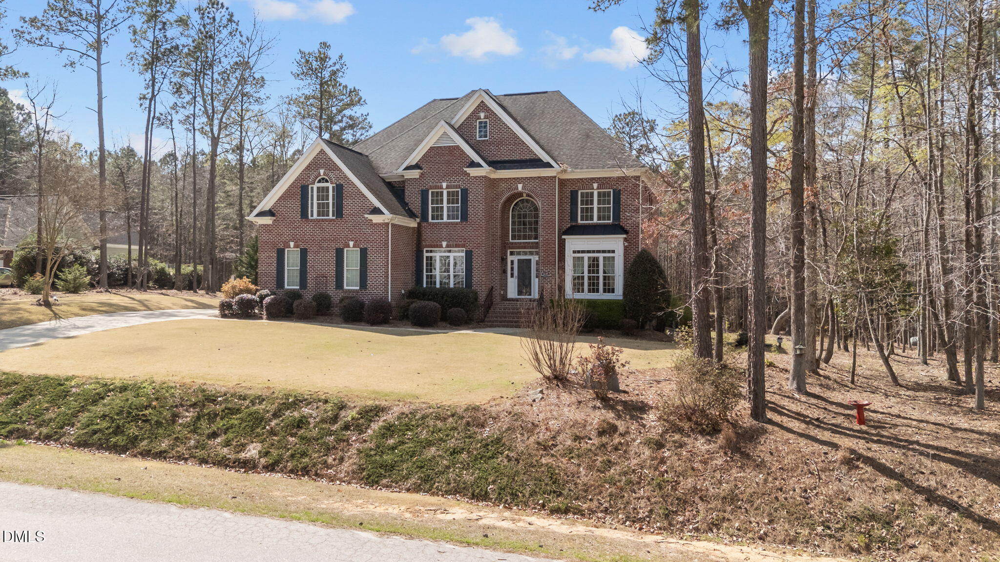 1405 Wakefield Farm Road Zebulon, NC 27597 - Photo 5 of 64 a front view of a house with a yard covered with snow and trees