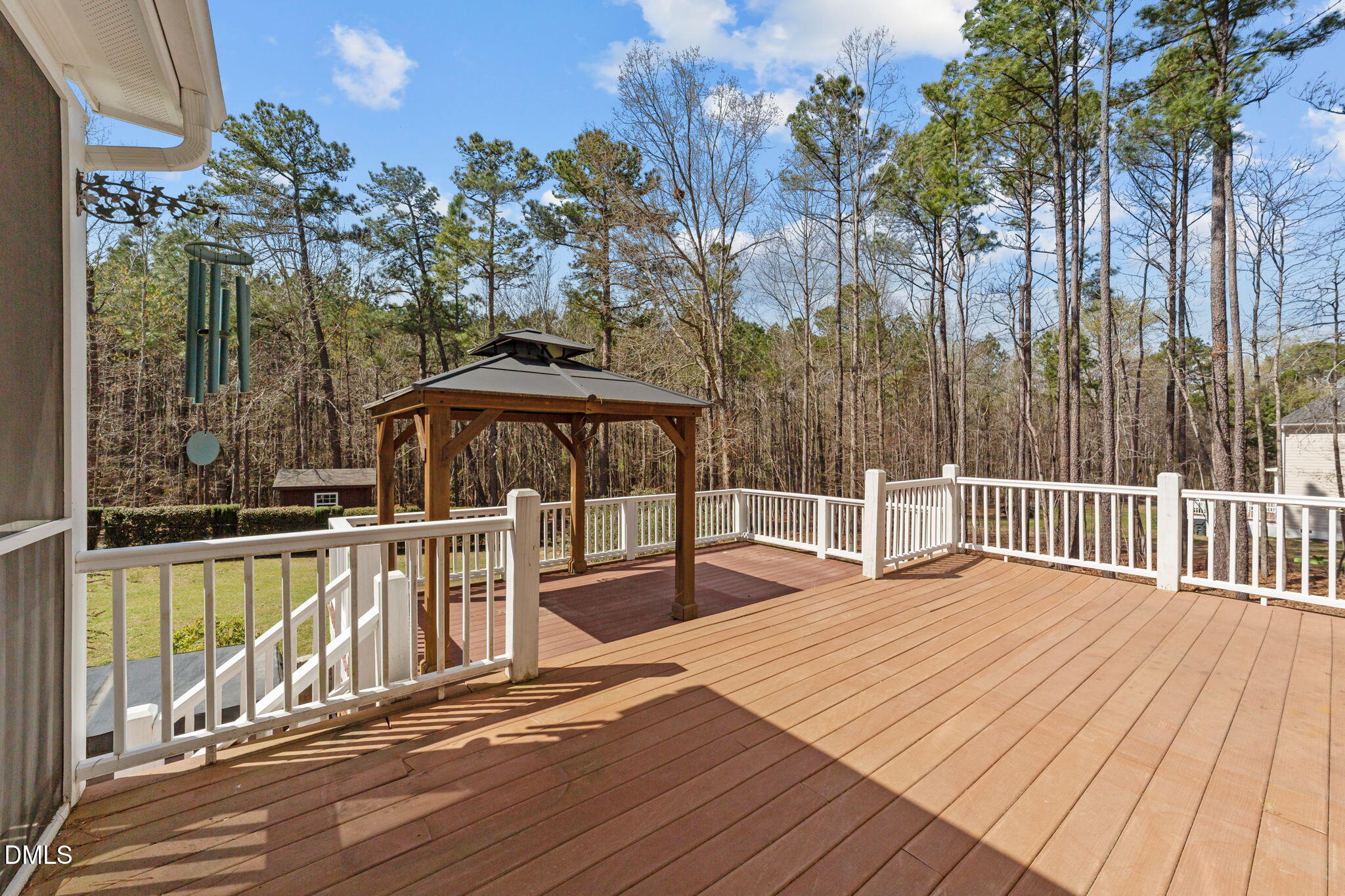 1405 Wakefield Farm Road Zebulon, NC 27597 - Photo 62 of 64 a view of a balcony with floor to ceiling window and wooden fence