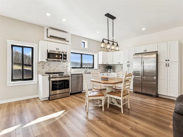 a kitchen with microwave a stove a sink and a refrigerator