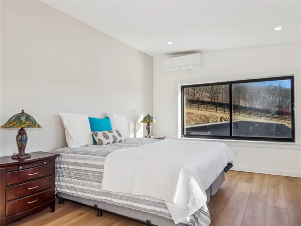 a big room with wooden floor and natural light