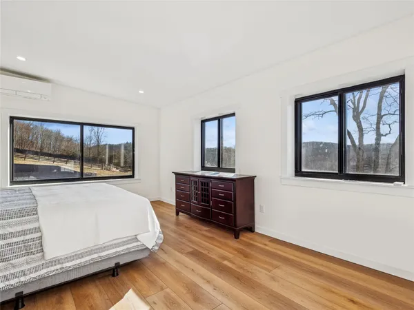 a bedroom with a bed and a large window