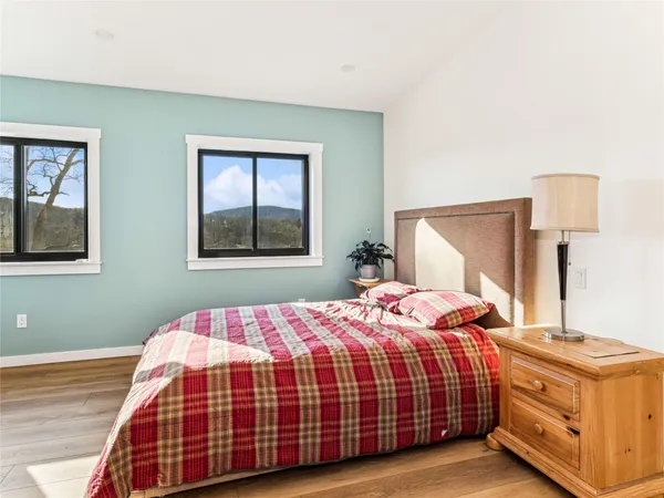 a bathroom with a granite countertop sink mirror and toilet