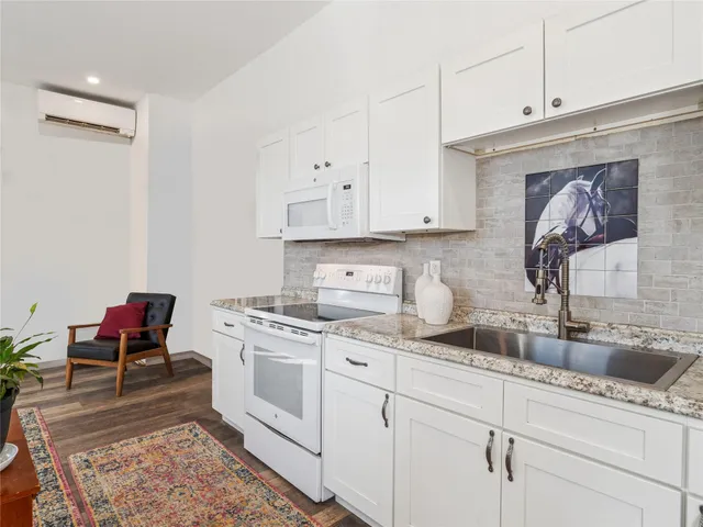 a kitchen with a sink stove and cabinets