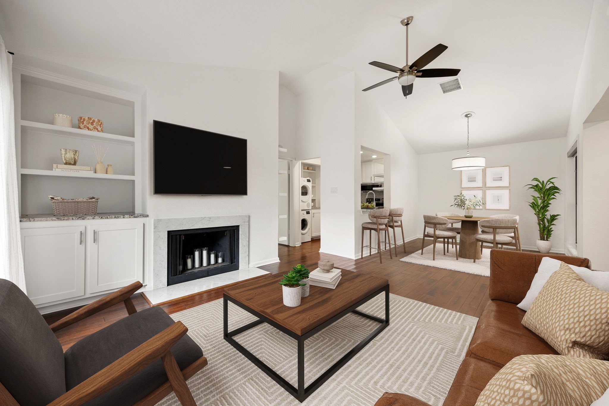 a living room with furniture a flat screen tv and a fireplace