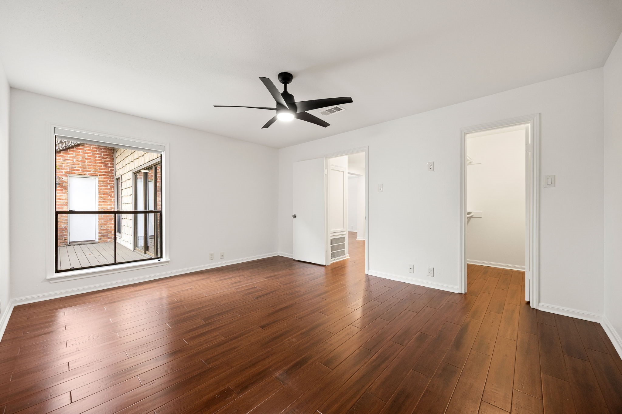2829 Timmons Lane, Unit 130 Houston, TX 77027 - Photo 14 of 23 a view of empty room with wooden floor and fan