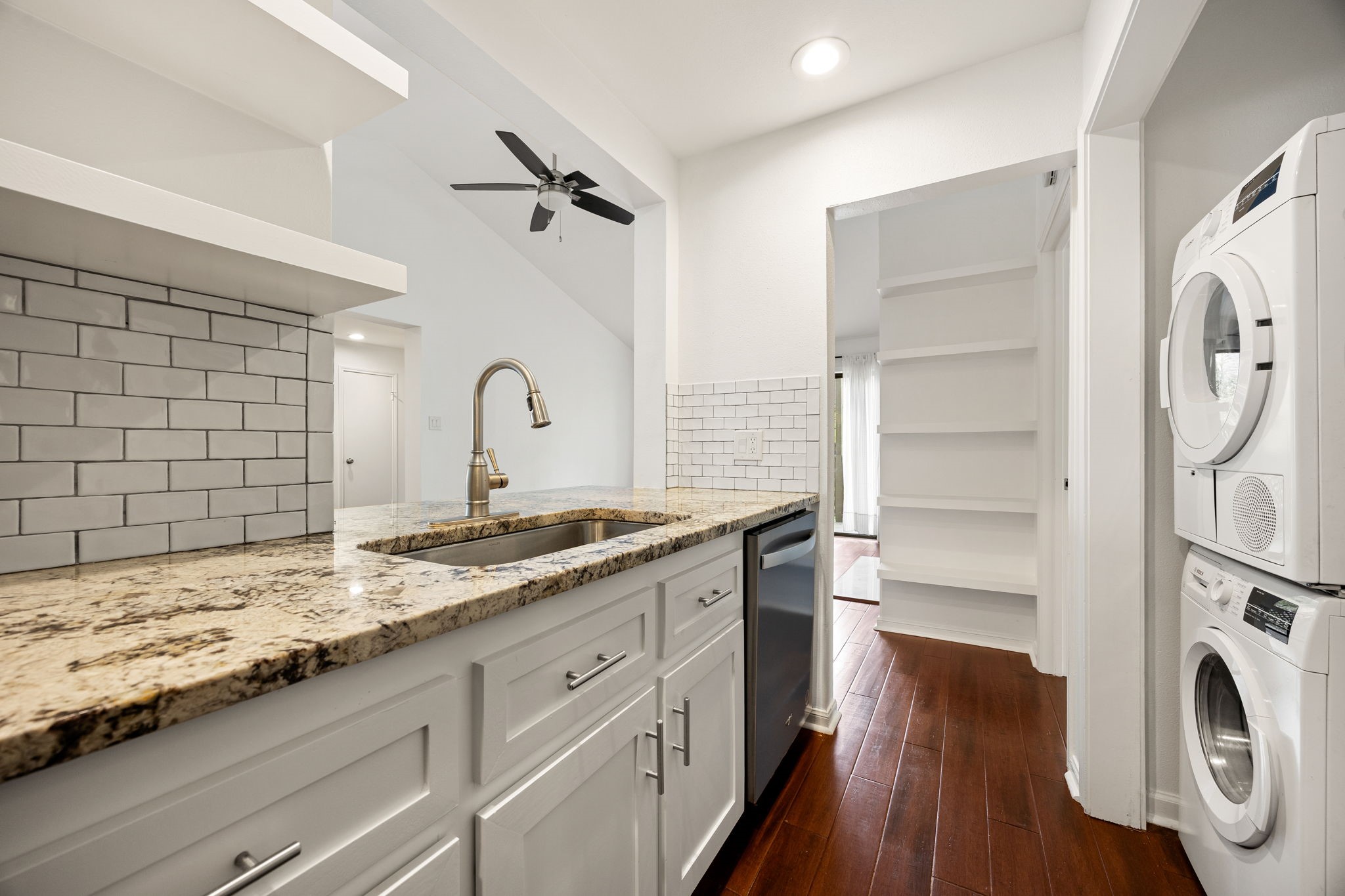 2829 Timmons Lane, Unit 130 Houston, TX 77027 - Photo 7 of 23 a bathroom with a granite countertop sink toilet and a large mirror
