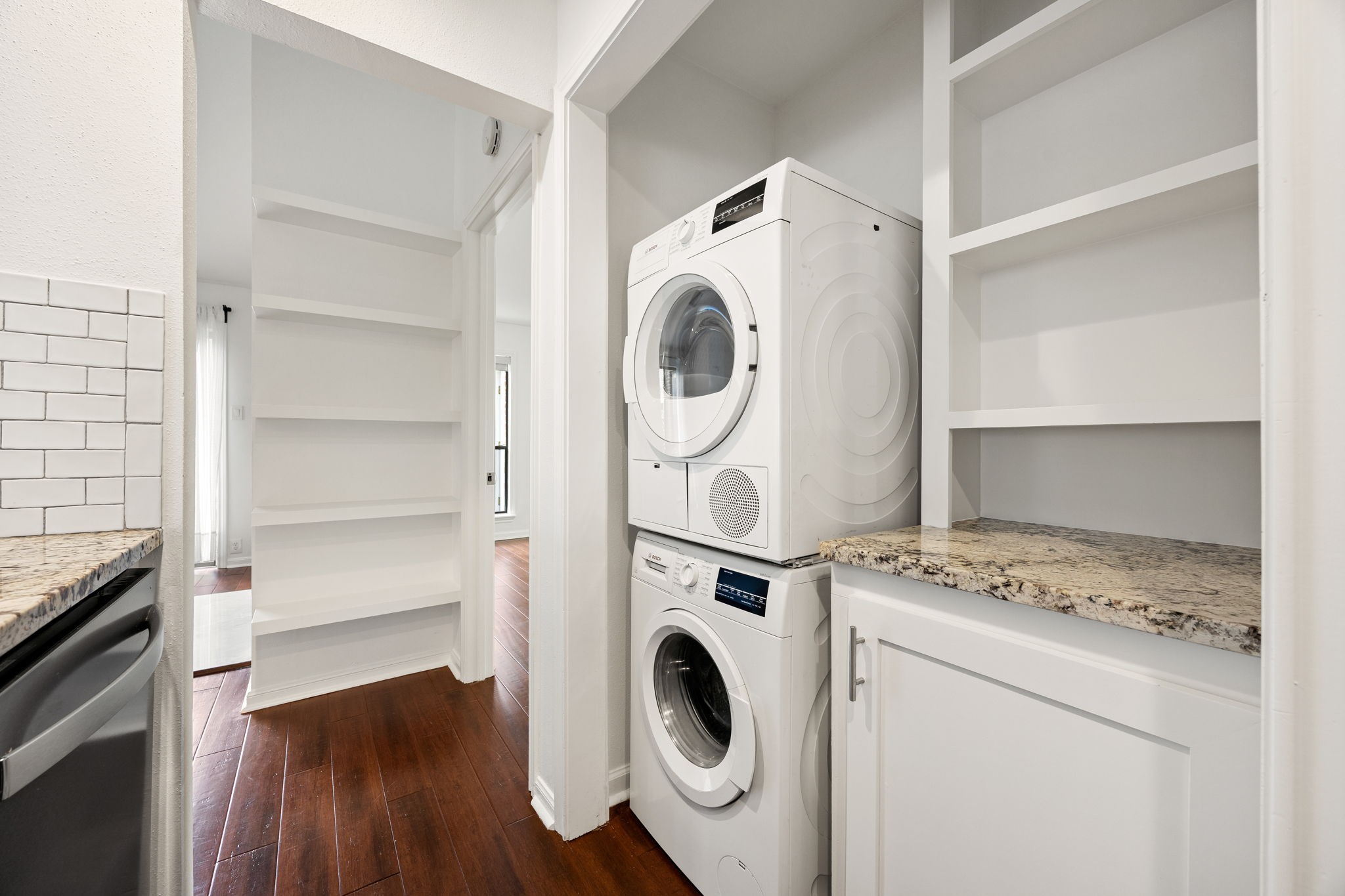 2829 Timmons Lane, Unit 130 Houston, TX 77027 - Photo 8 of 23 a utility room with dryer washer and a view of bedroom