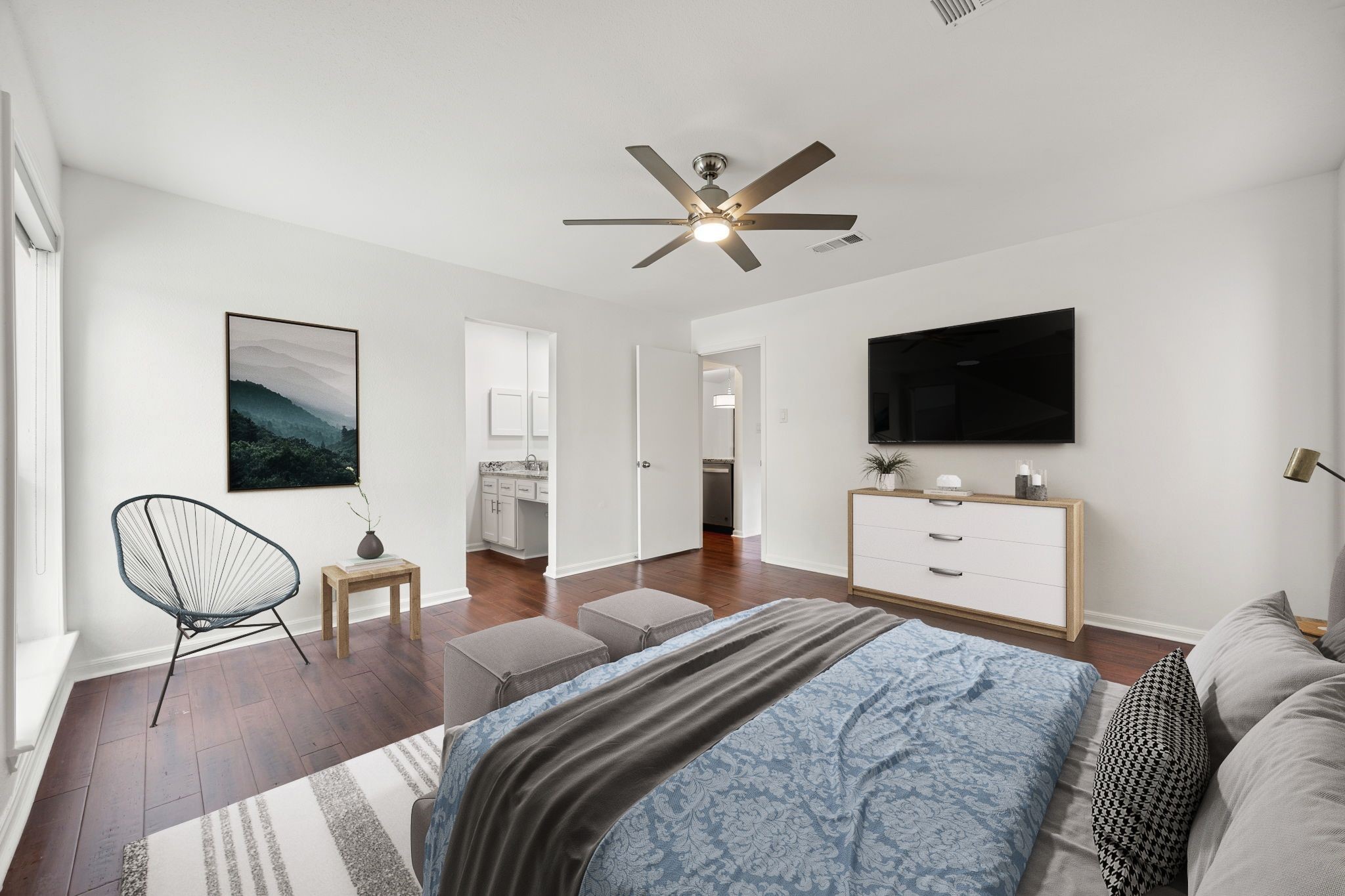 2829 Timmons Lane, Unit 130 Houston, TX 77027 - Photo 10 of 23 a bedroom with furniture and a flat screen tv