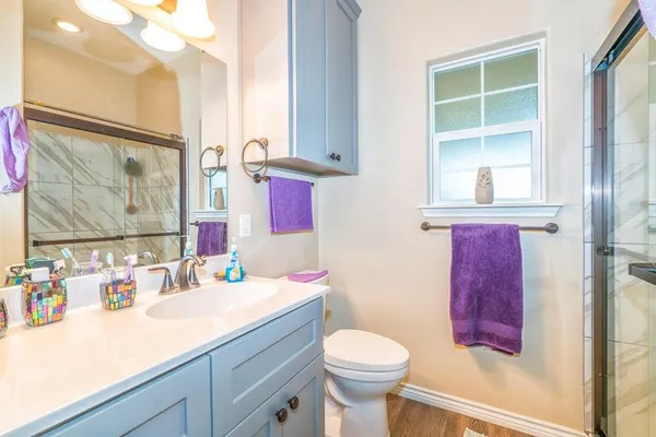 a bathroom with a sink a toilet and shower curtain