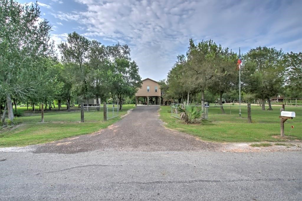 6026 County Road 73 Robstown, TX 78380 - Photo 2 of 30 a view of a house with a big yard and a large trees