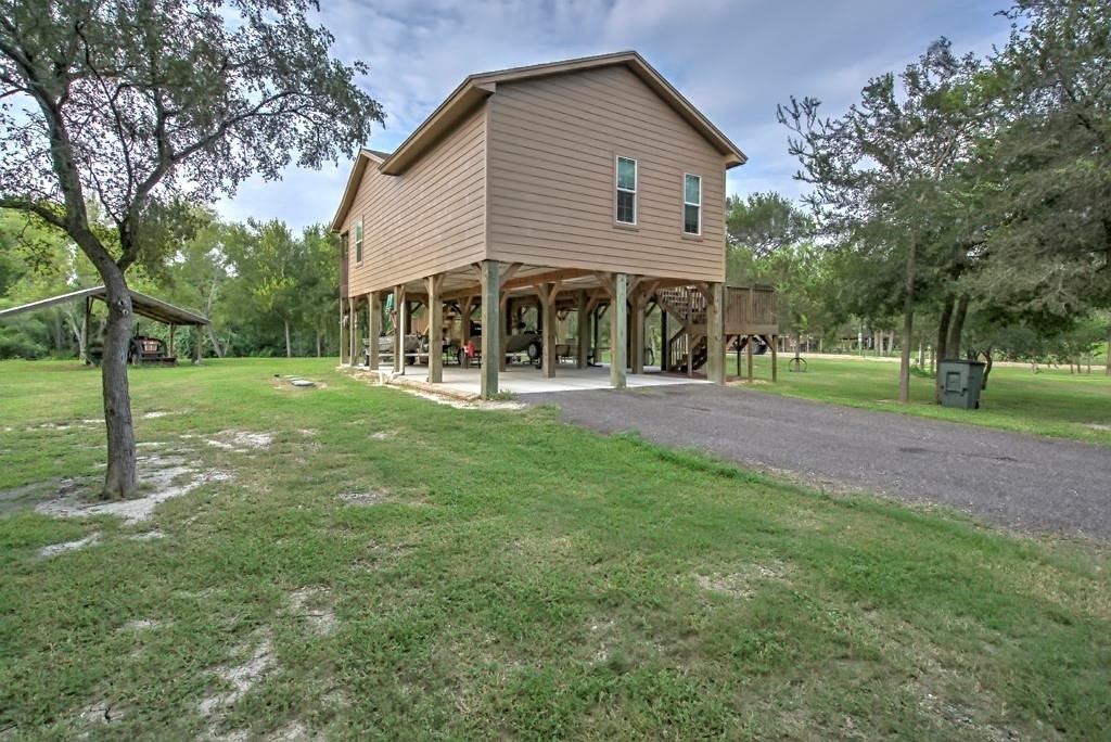 6026 County Road 73 Robstown, TX 78380 - Photo 21 of 30 a front view of a house with a yard and trees