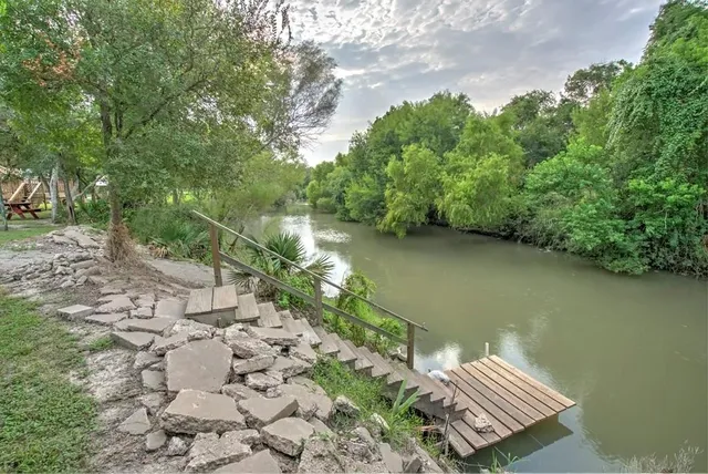 an aerial view of a house with garden space and street view