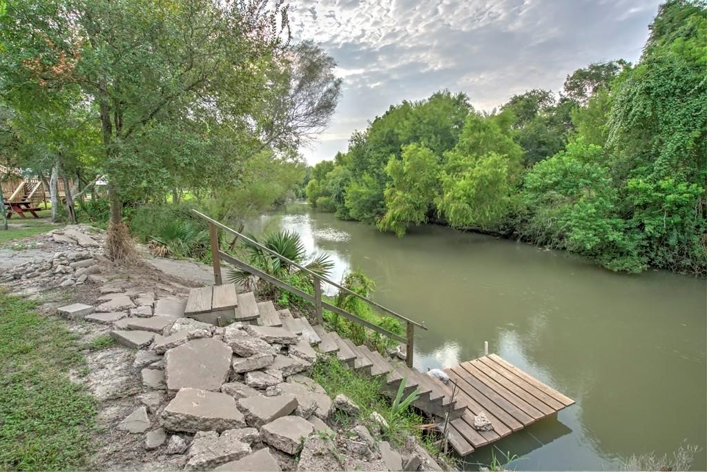 6026 County Road 73 Robstown, TX 78380 - Photo 25 of 30 a view of a yard with wooden floor and lake view