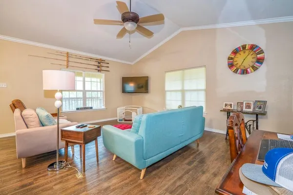 a living room with furniture and a flat screen tv