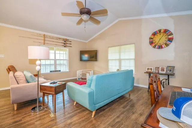 a living room with furniture and a flat screen tv
