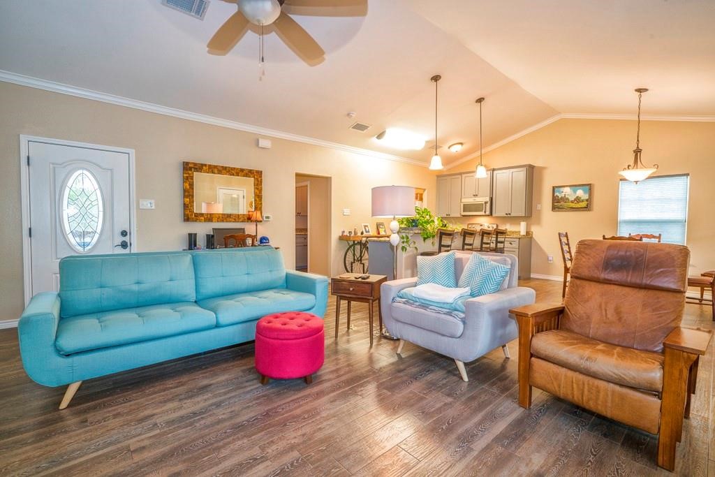 6026 County Road 73 Robstown, TX 78380 - Photo 6 of 30 a living room with furniture kitchen view and a chandelier