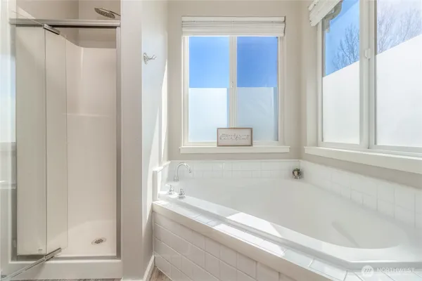 a bathroom with a bathtub and a shower